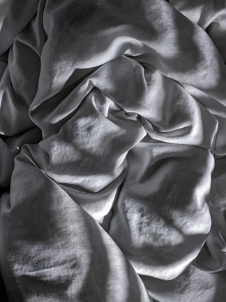 An abstract close-up of textured fabric folds creating shadow patterns.