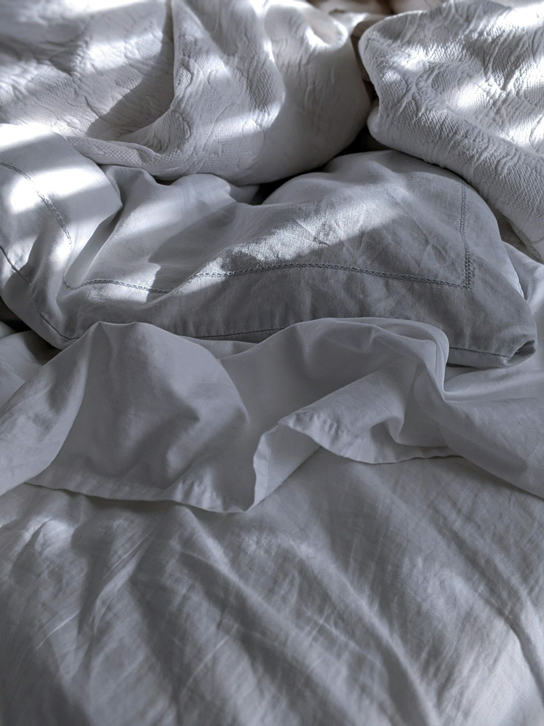 white bed linen on bed