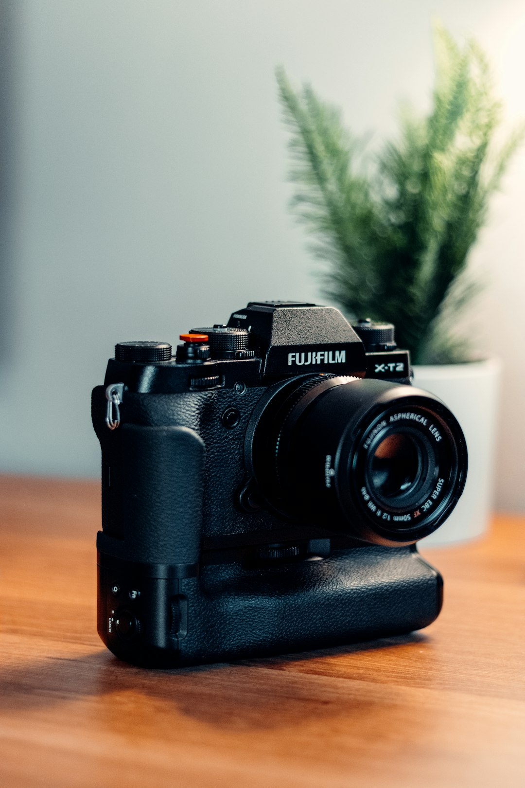 black nikon dslr camera on brown wooden table