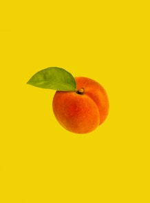 orange fruit with green leaves
