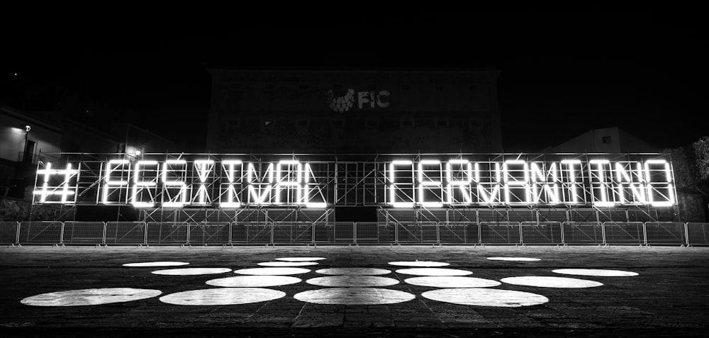 a black and white photo of a neon sign