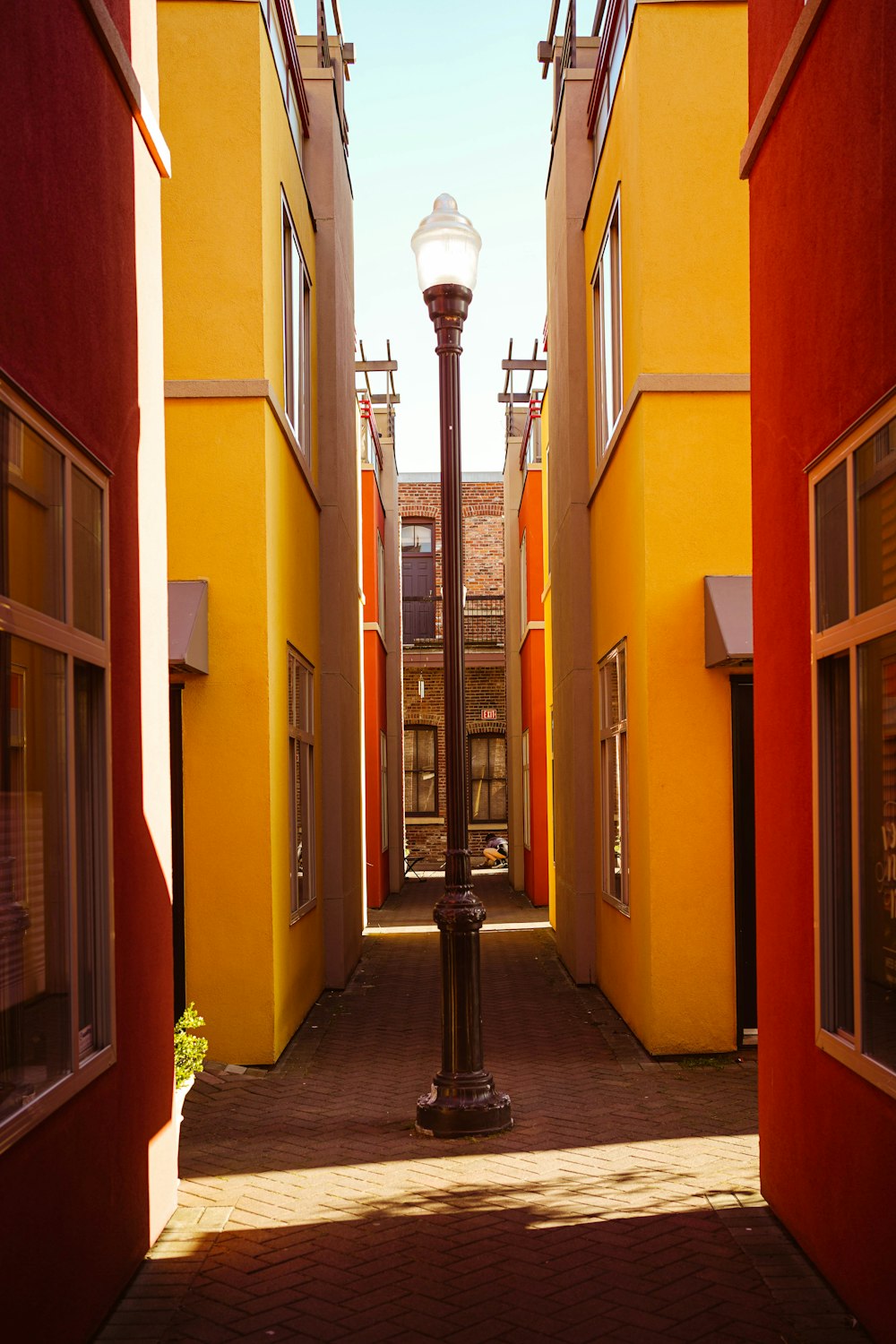 black street light near orange concrete building