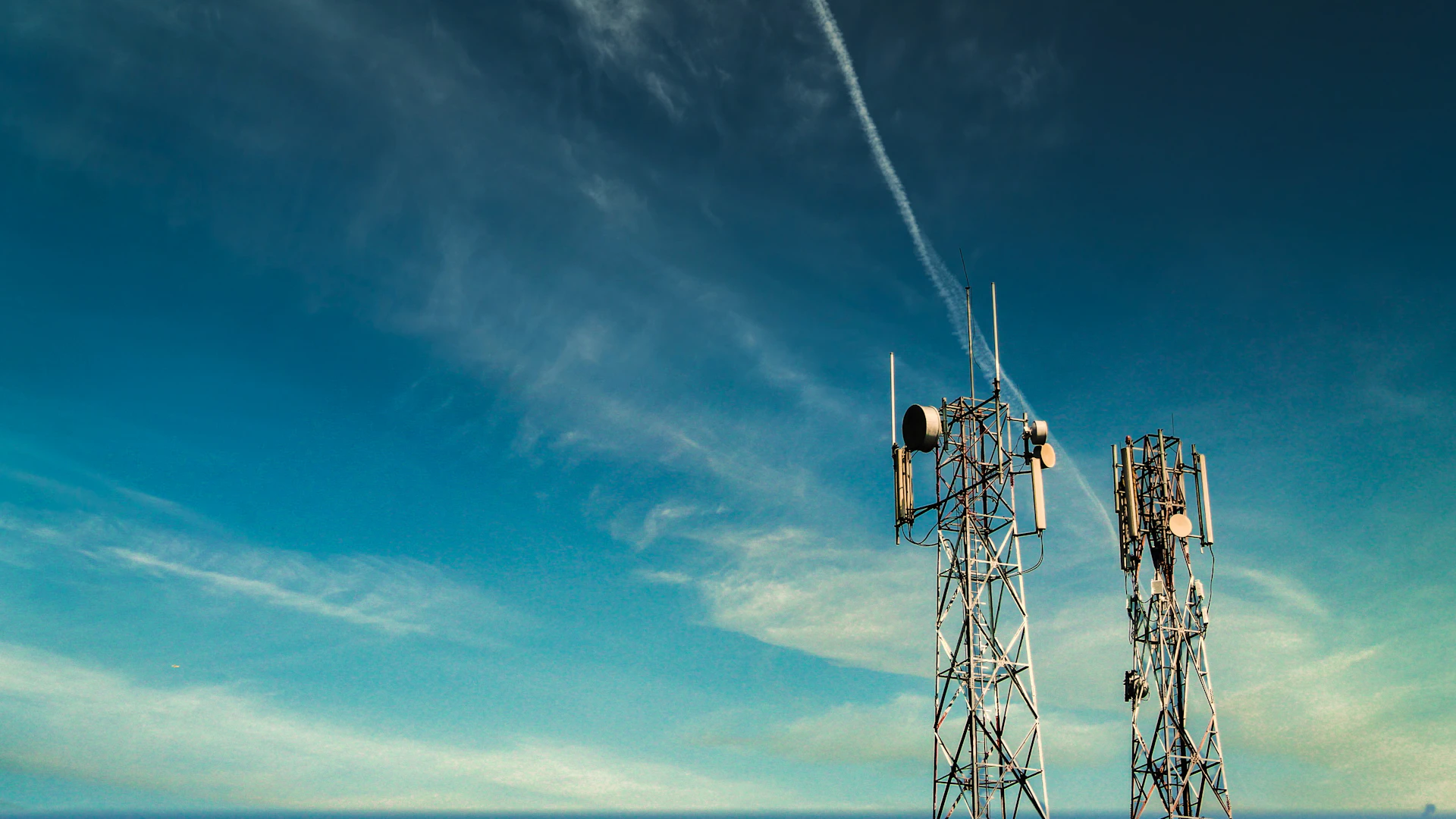 Cell tower against bright sky