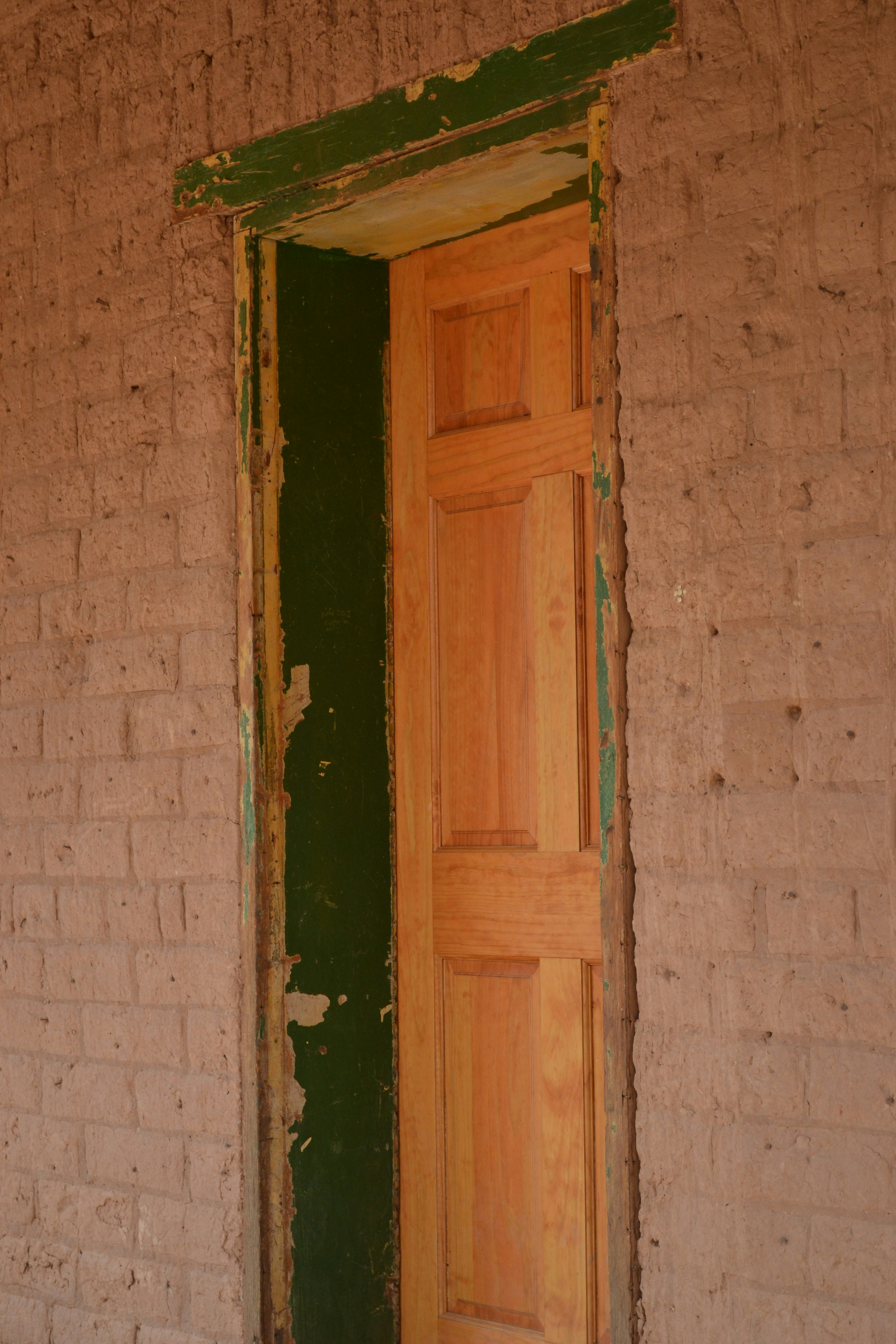 brown wooden door on gray concrete wall