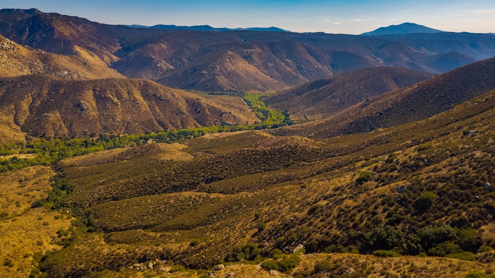 green and brown mountains under white sky during daytime