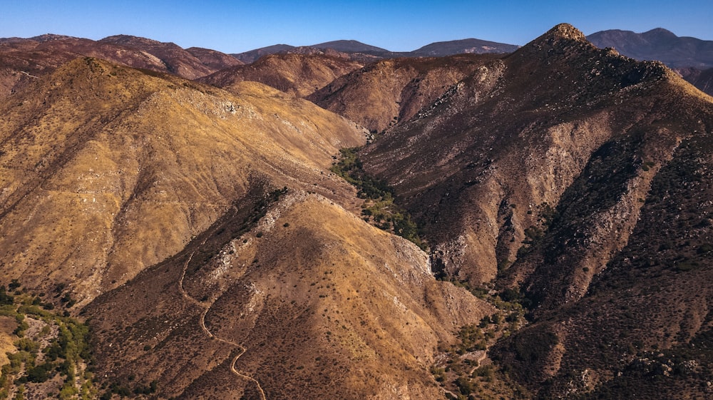 brown and green mountains under blue sky during daytime