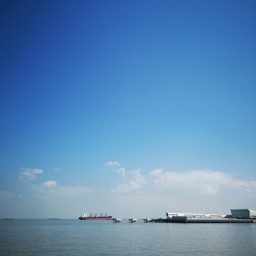 white ship on sea under blue sky during daytime