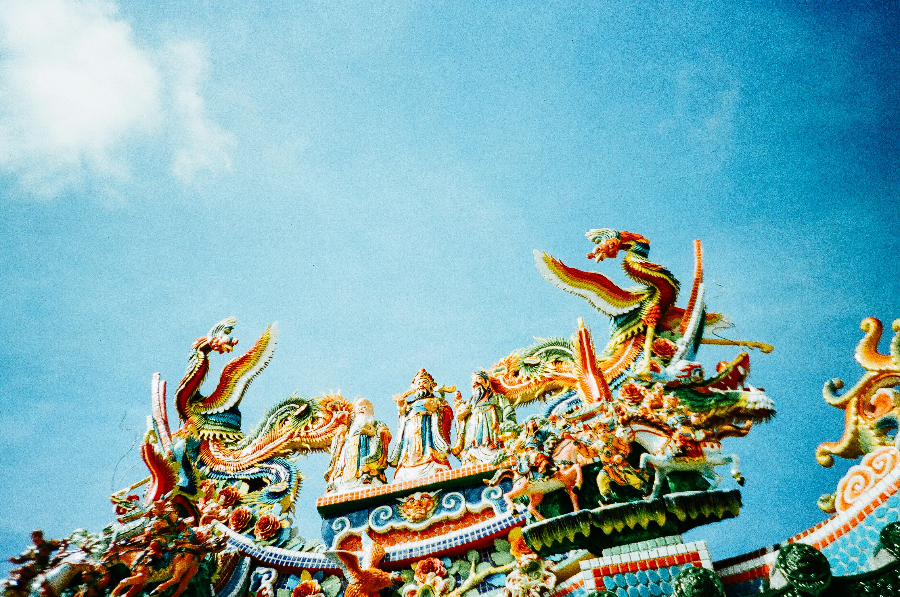 green and brown dragon statue under blue sky during daytime