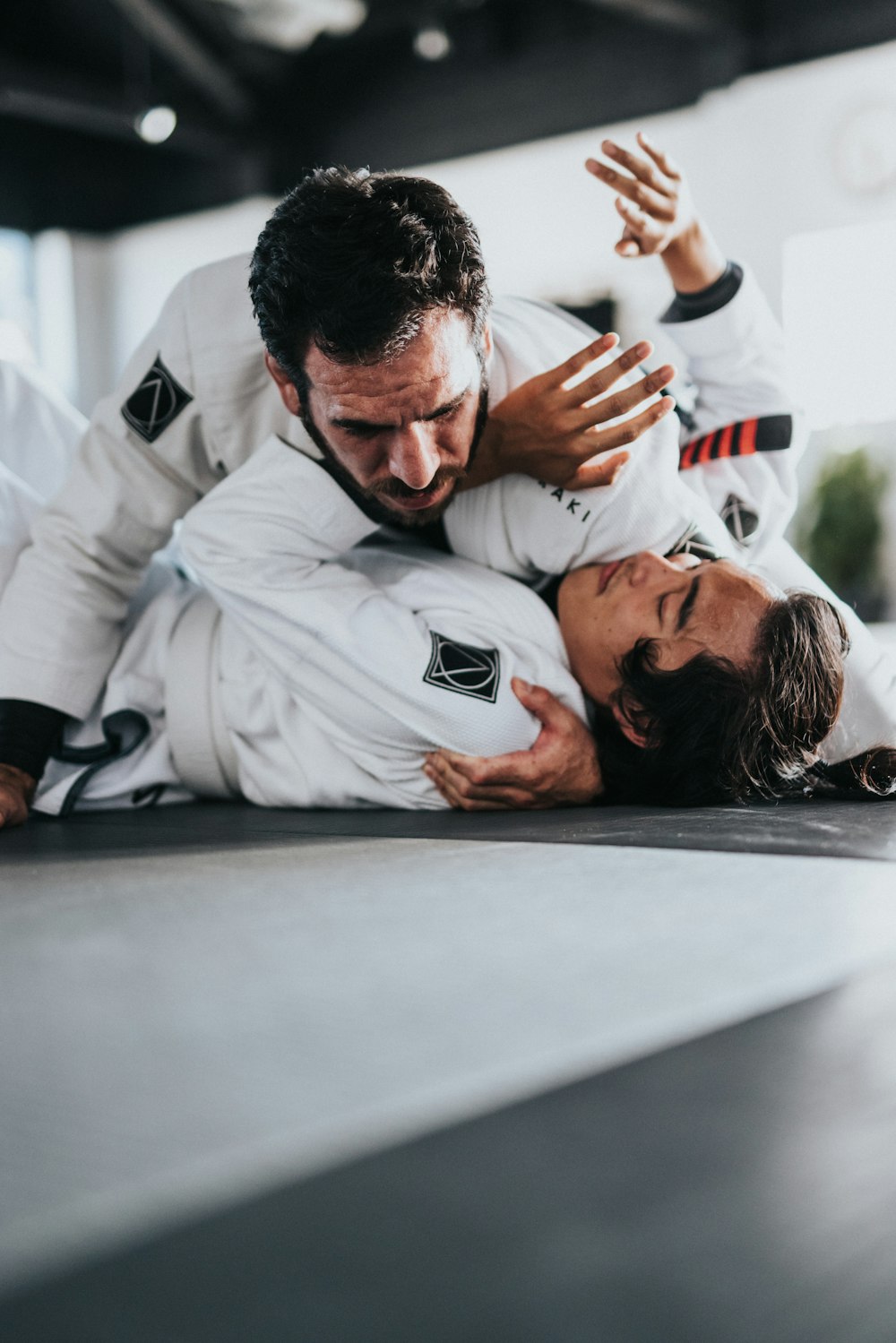 man in white nike long sleeve shirt lying on floor