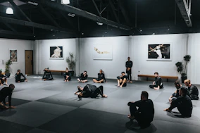 Action shot capturing a high-energy martial arts session with team members.