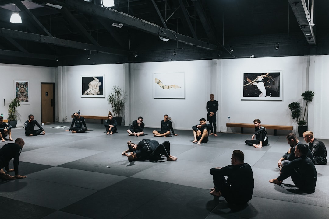 people sitting on floor in front of white wall,