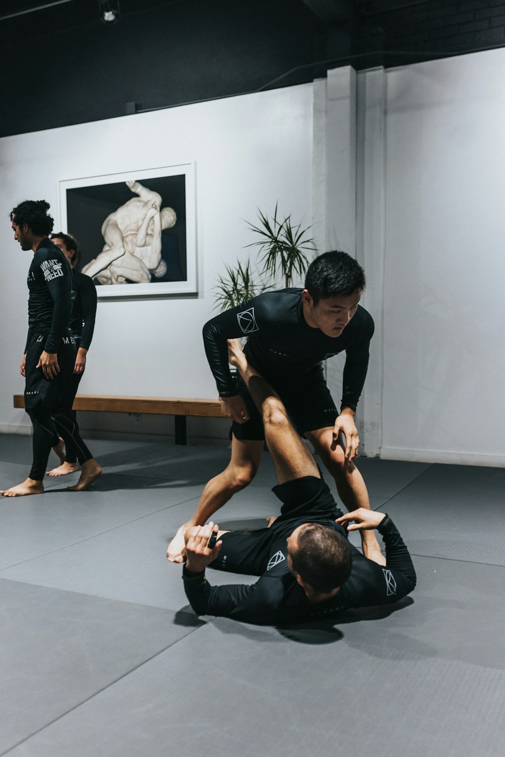 man in black t-shirt and black pants doing push up