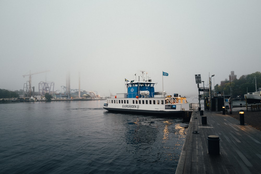 white and blue ship on sea during daytime