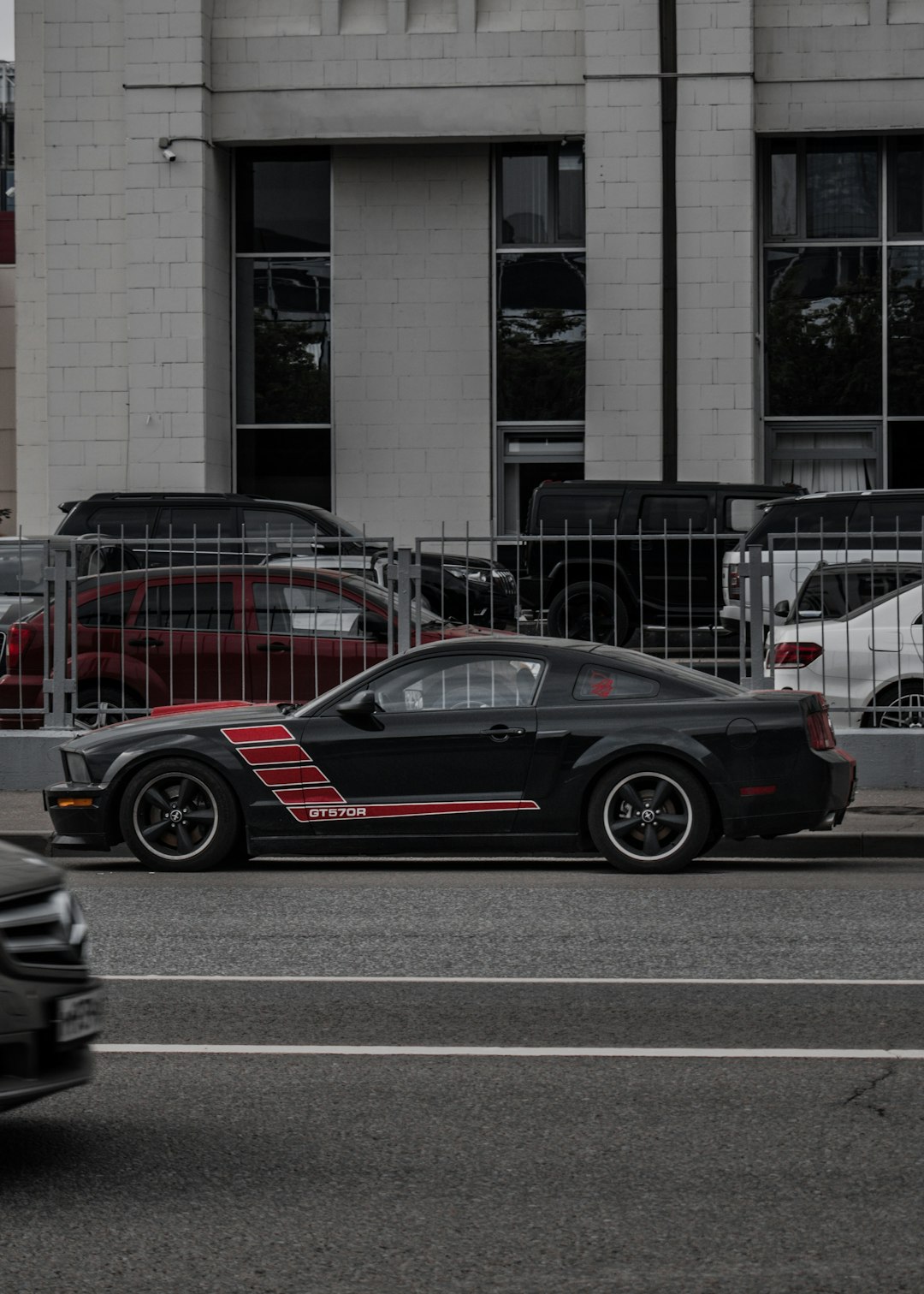 black and red car parked beside building