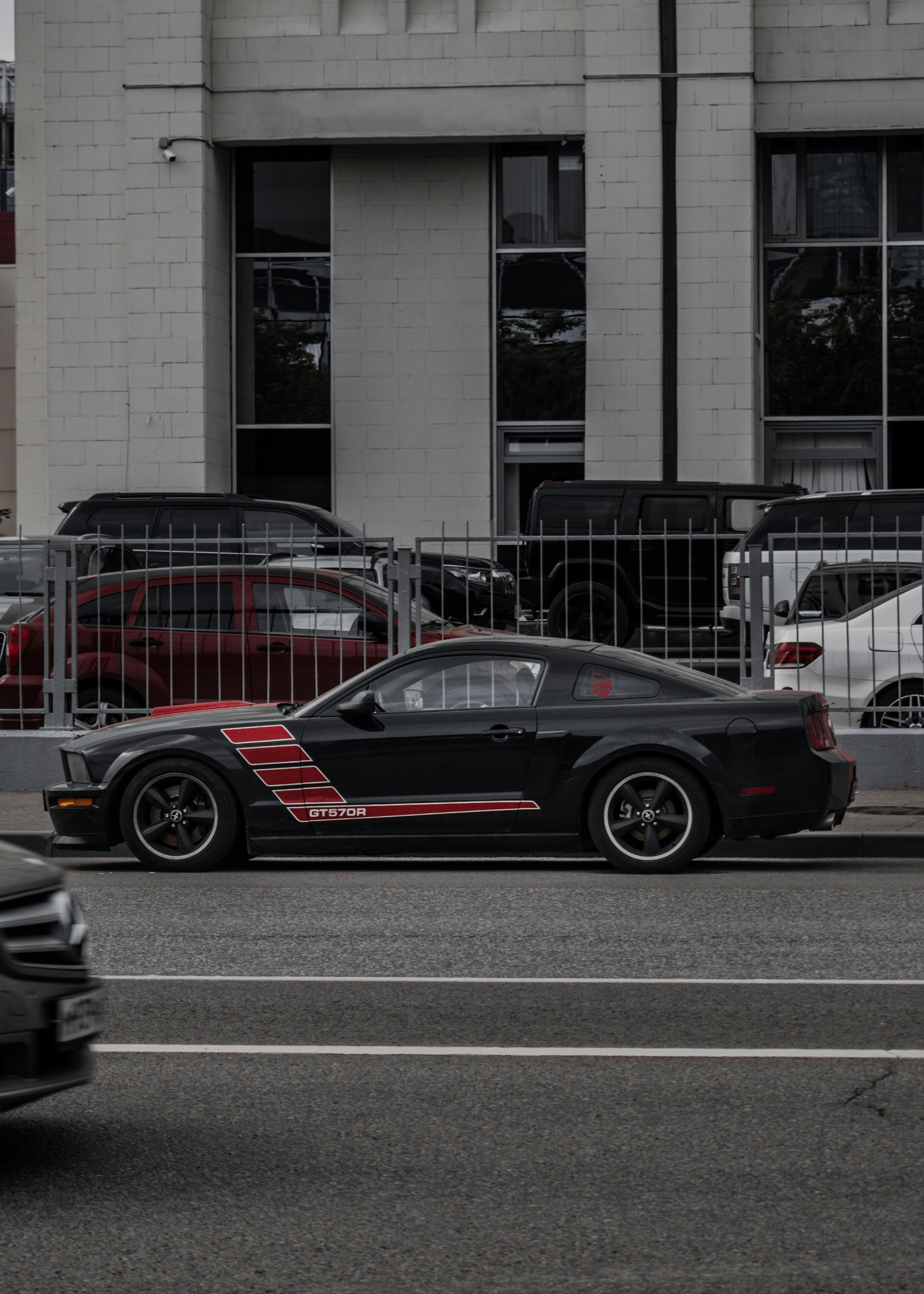 black and red car parked beside building