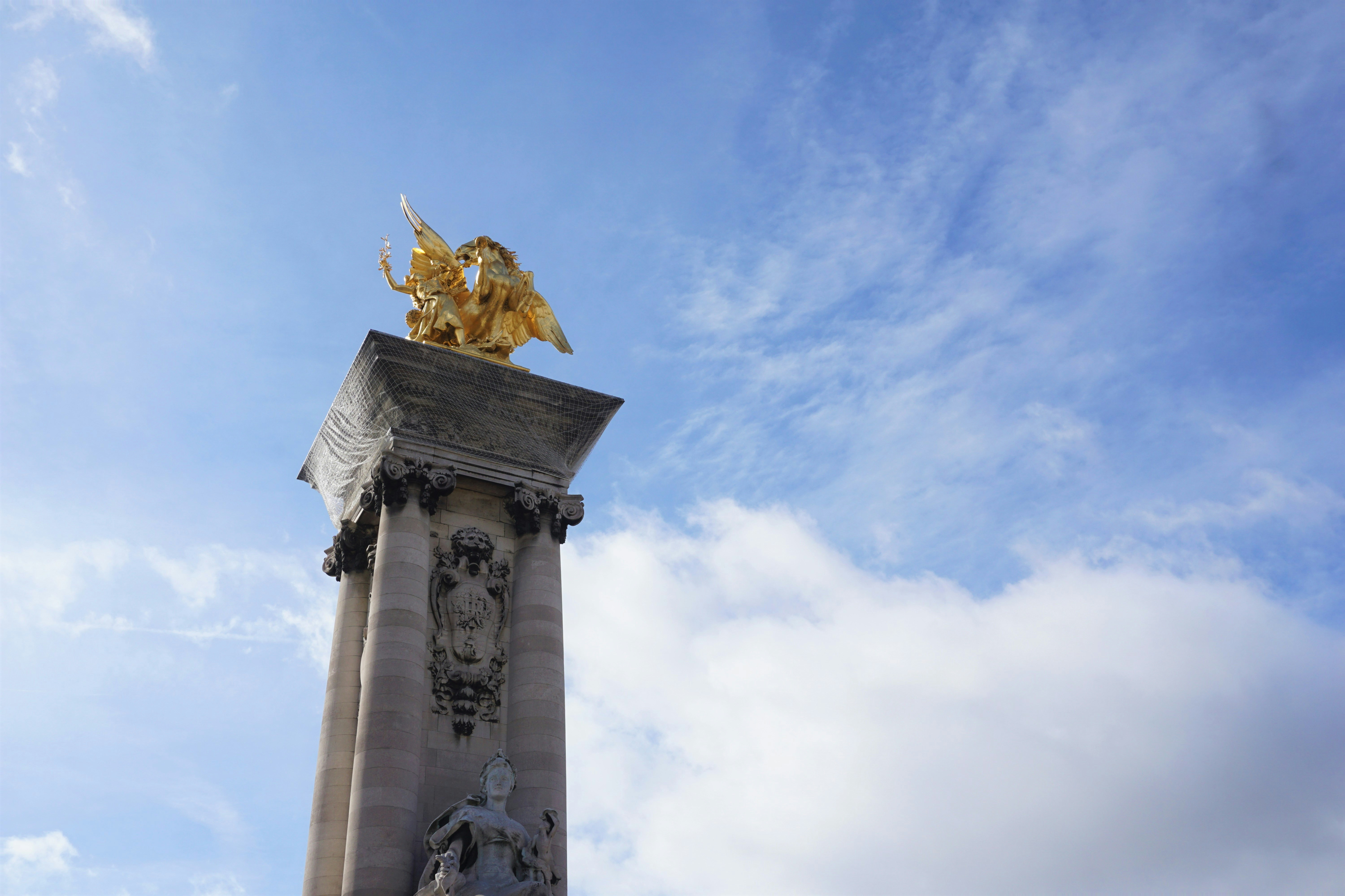 gold statue under blue sky during daytime, 