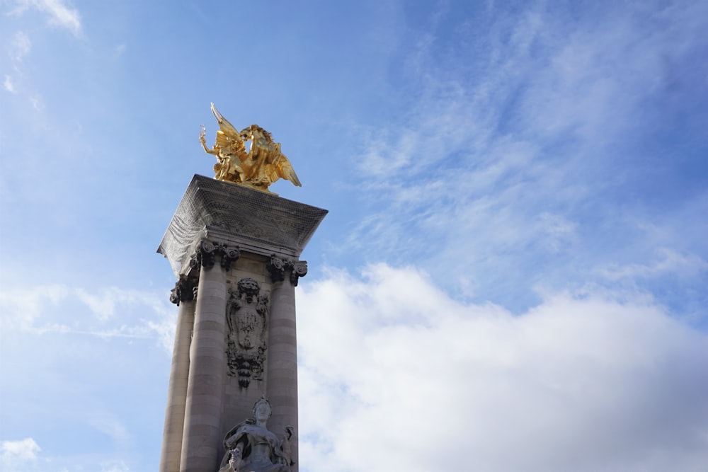 gold statue under blue sky during daytime