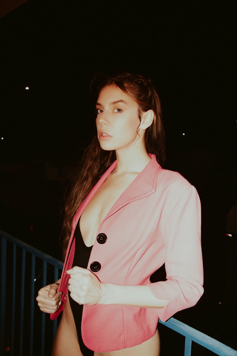 woman in pink blazer standing and smiling