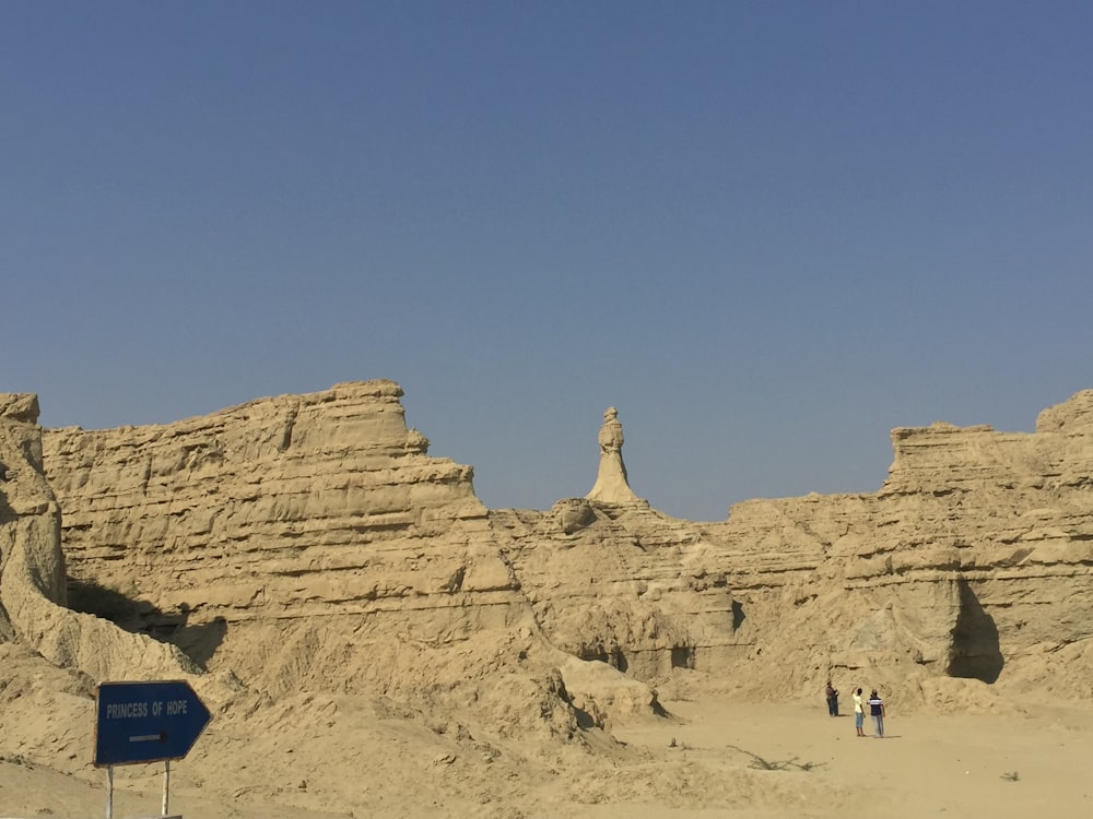 people walking on brown sand during daytime