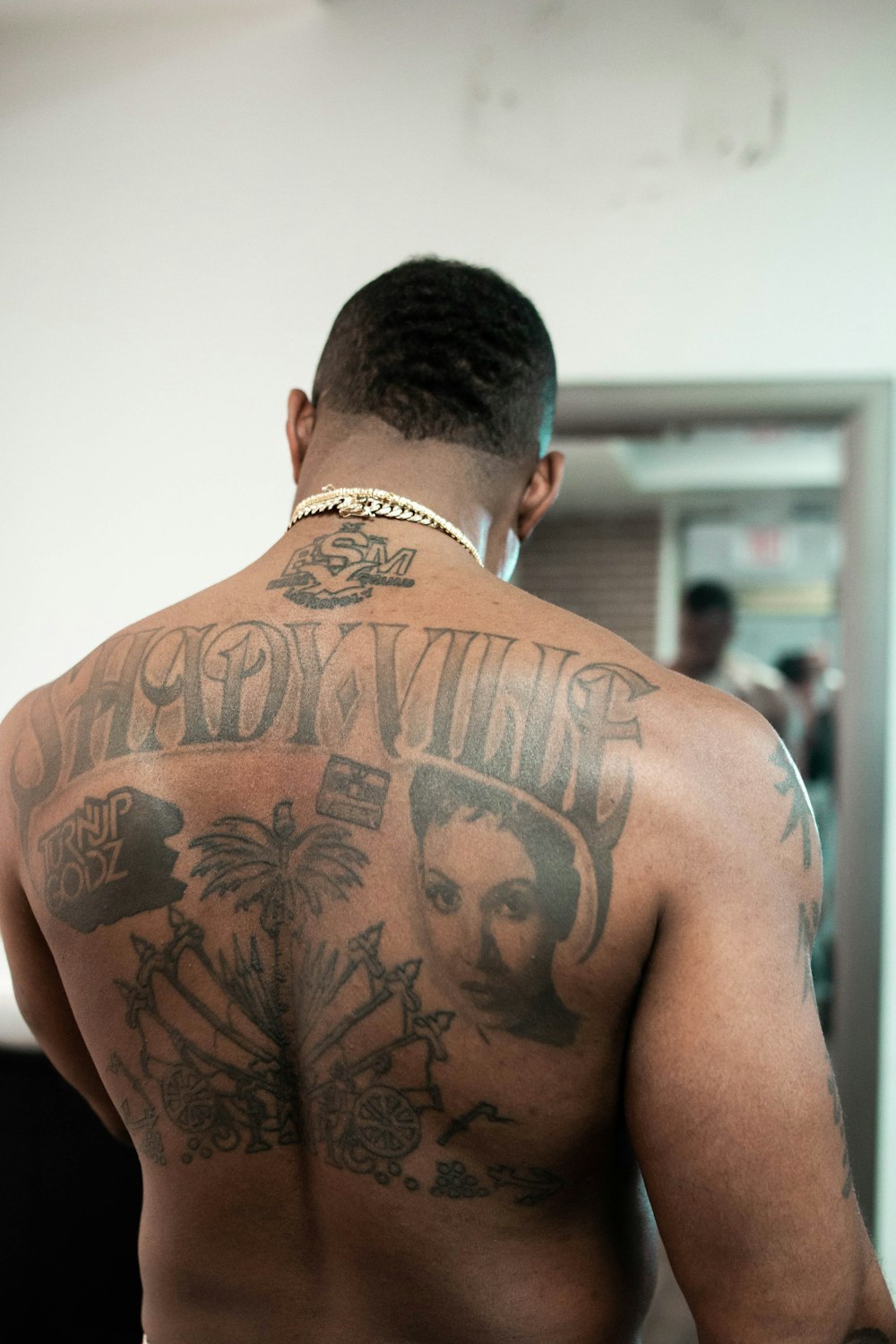 man with tattoo on his back