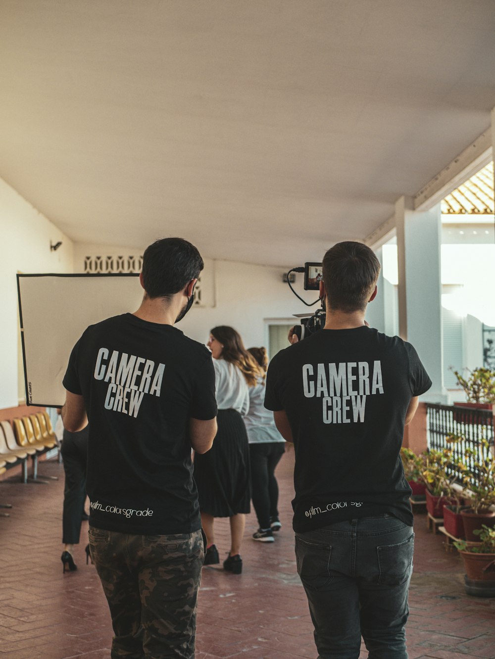 man in black and white crew neck t-shirt standing beside man in black crew neck