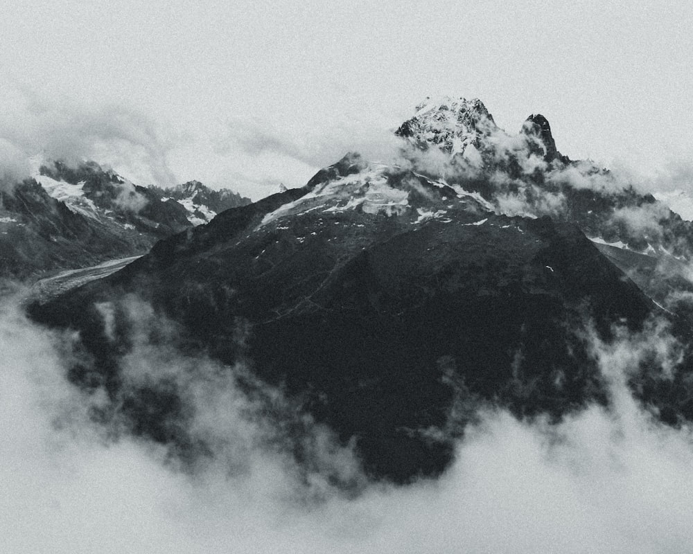 black and white mountain under white clouds