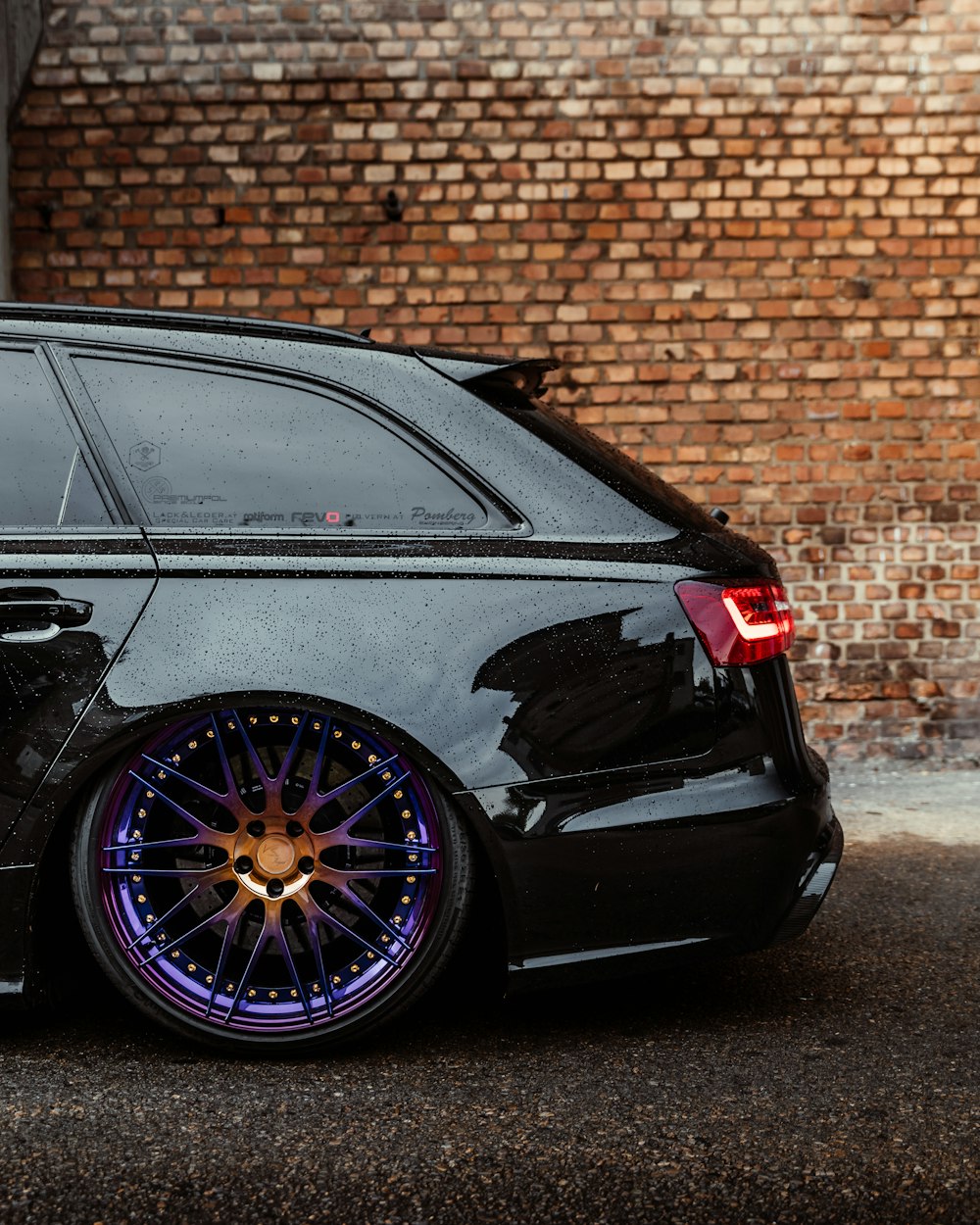 black bmw m 3 parked beside brown brick wall