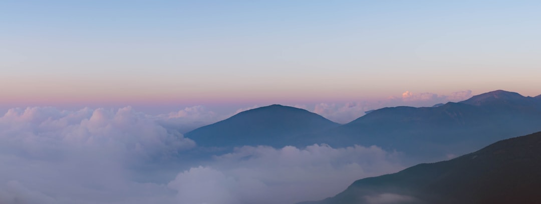 mountain range under white clouds