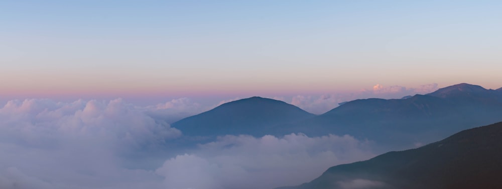 mountain range under white clouds