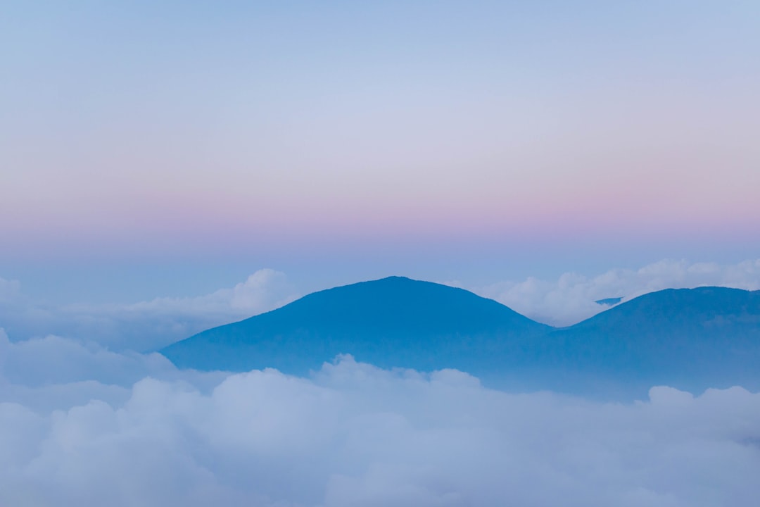 mountain range under white clouds