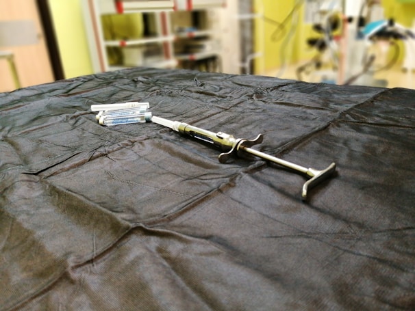 An assortment of syringes and vials on a sterile surface.