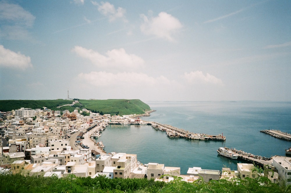 white and brown concrete buildings near body of water during daytime