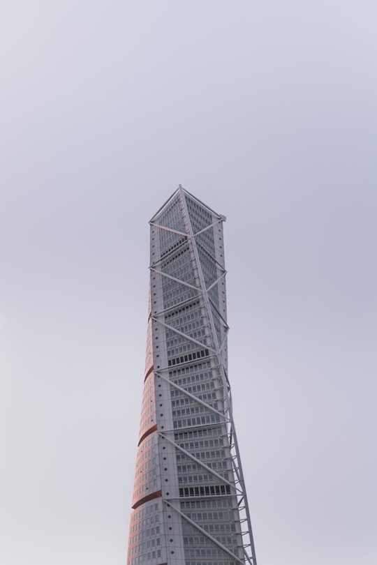 low angle photography of gray metal tower in Turning Torso Building Sweden
