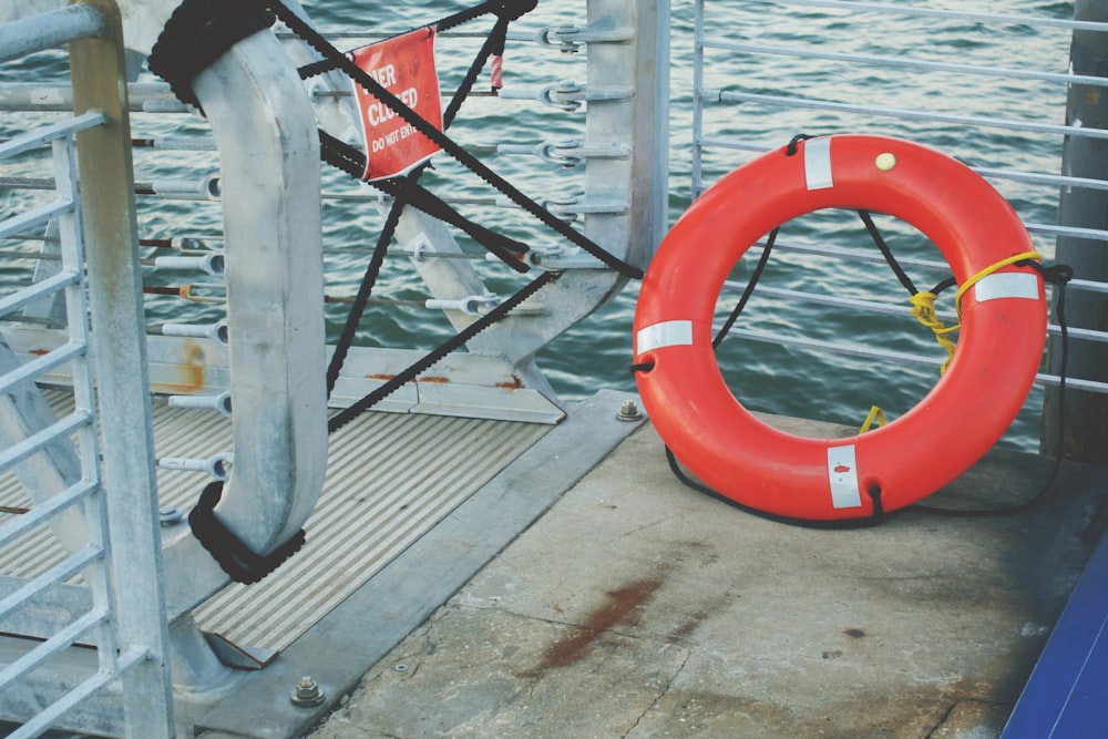 red and white inflatable ring on brown wooden dock
