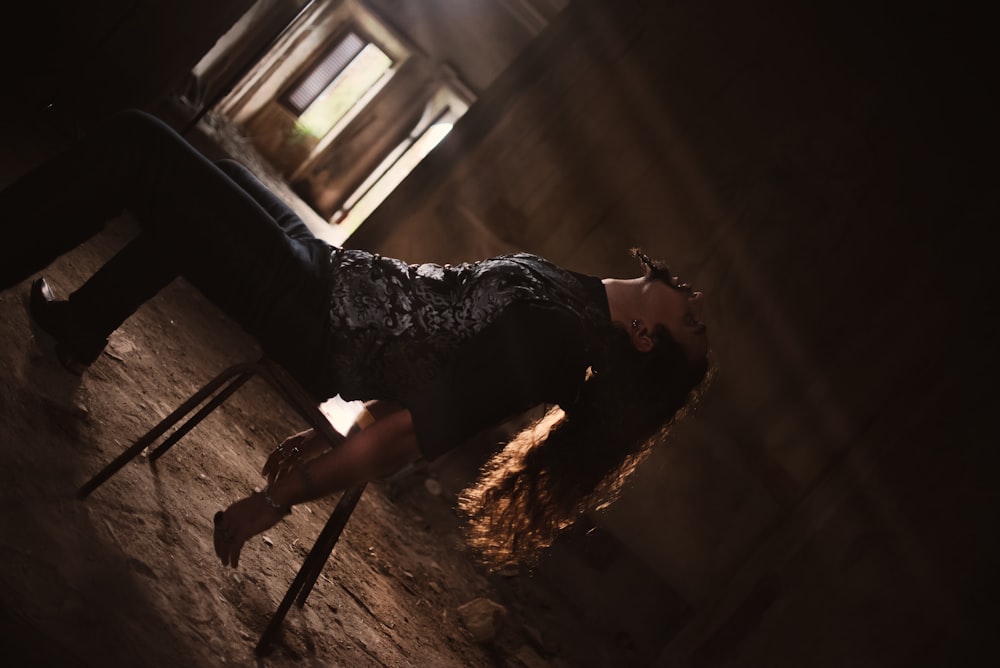 woman in black and white floral dress standing on brown wooden ladder