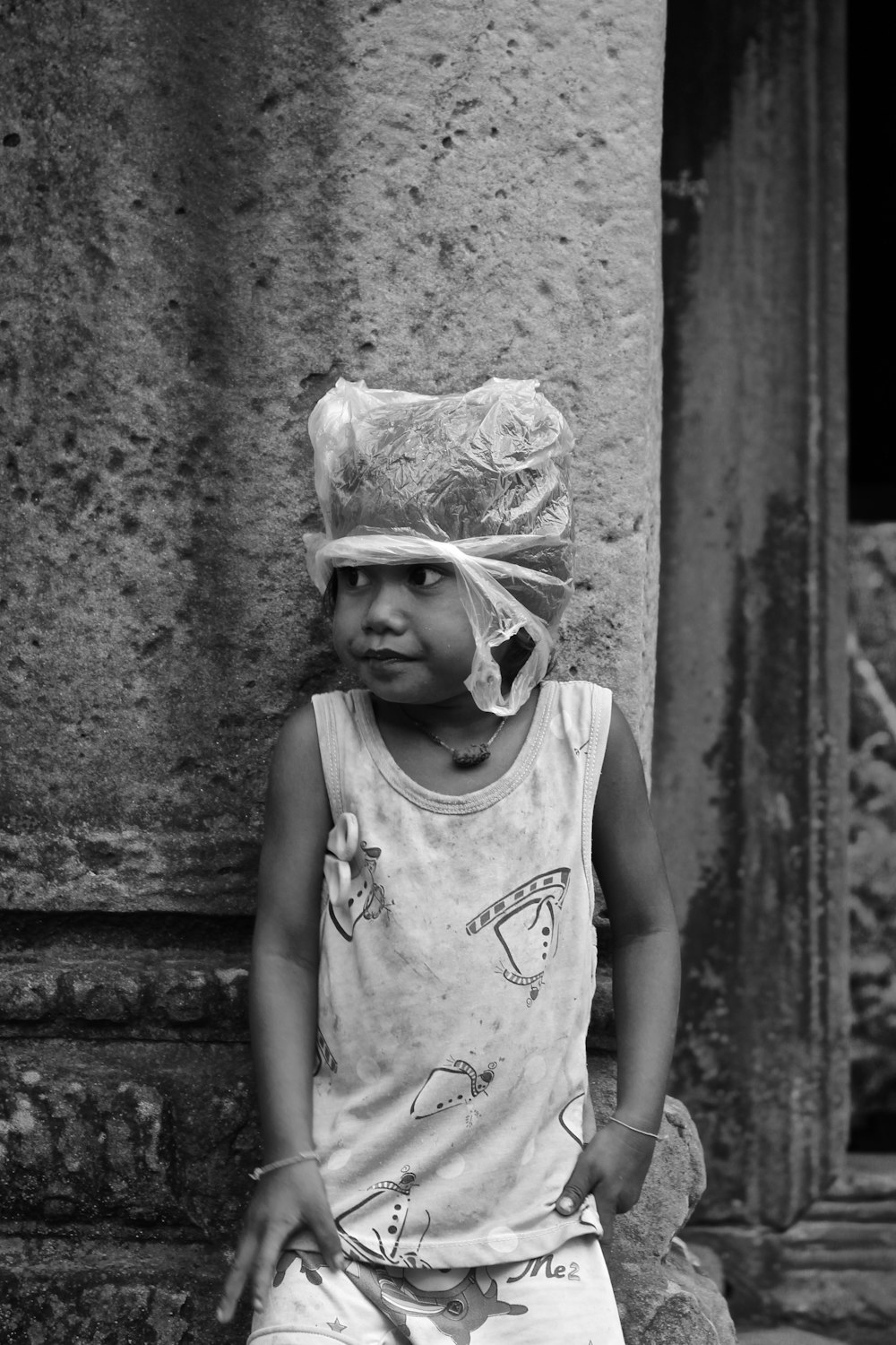 grayscale photo of girl in tank top wearing white hat