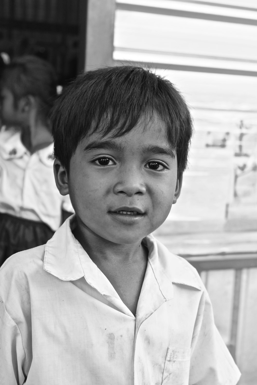 grayscale photo of boy in button up shirt