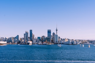 city skyline across body of water during daytime