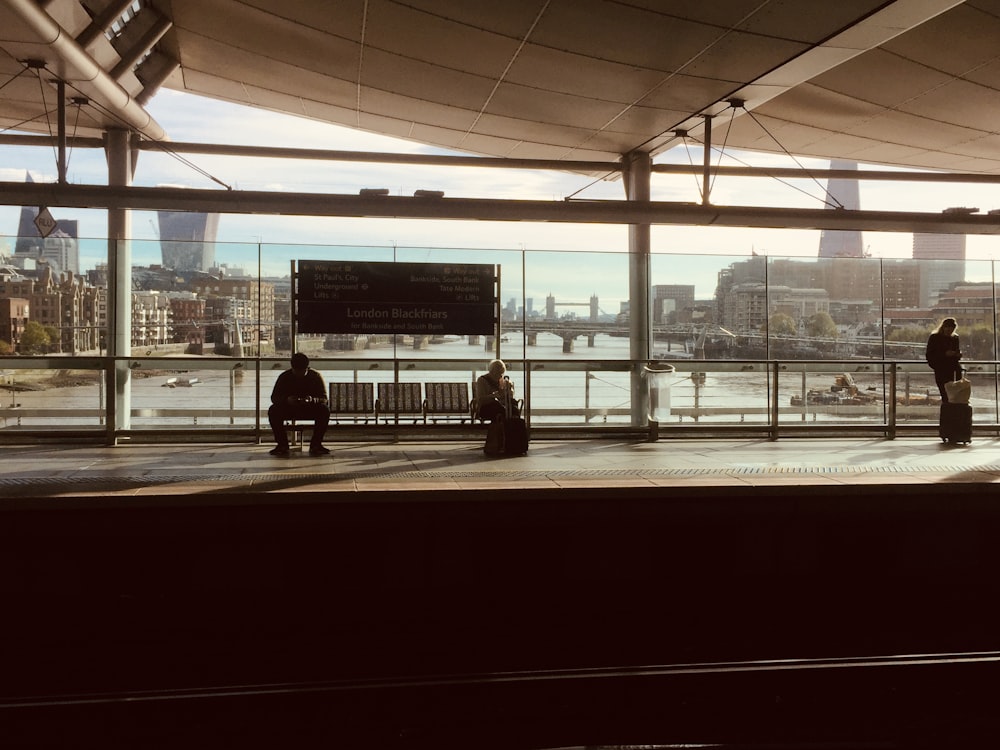 2 person standing near glass window during daytime