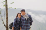 man hugging woman happily in an outdoor setting.