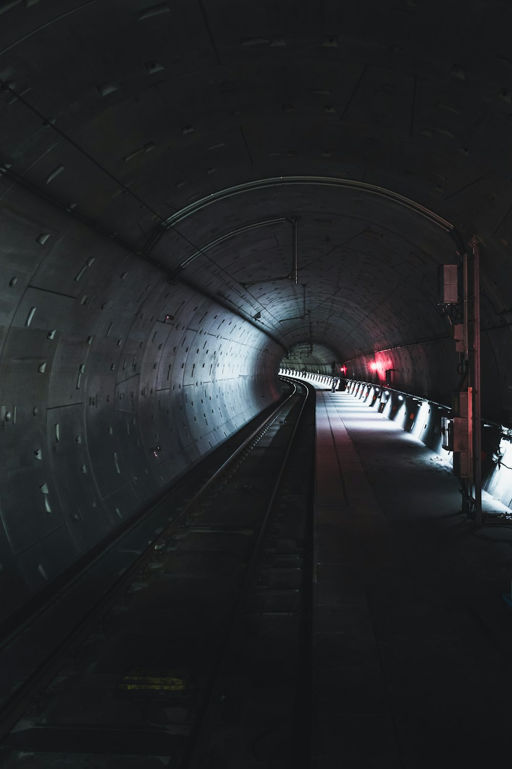 black and white tunnel with red lights