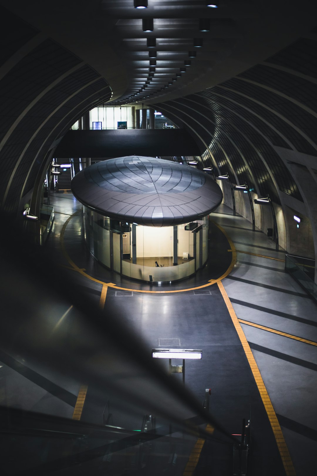 gray and black tunnel with white ceiling