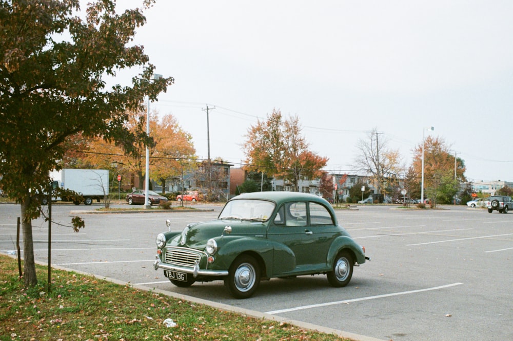 green sedan on gray asphalt road during daytime