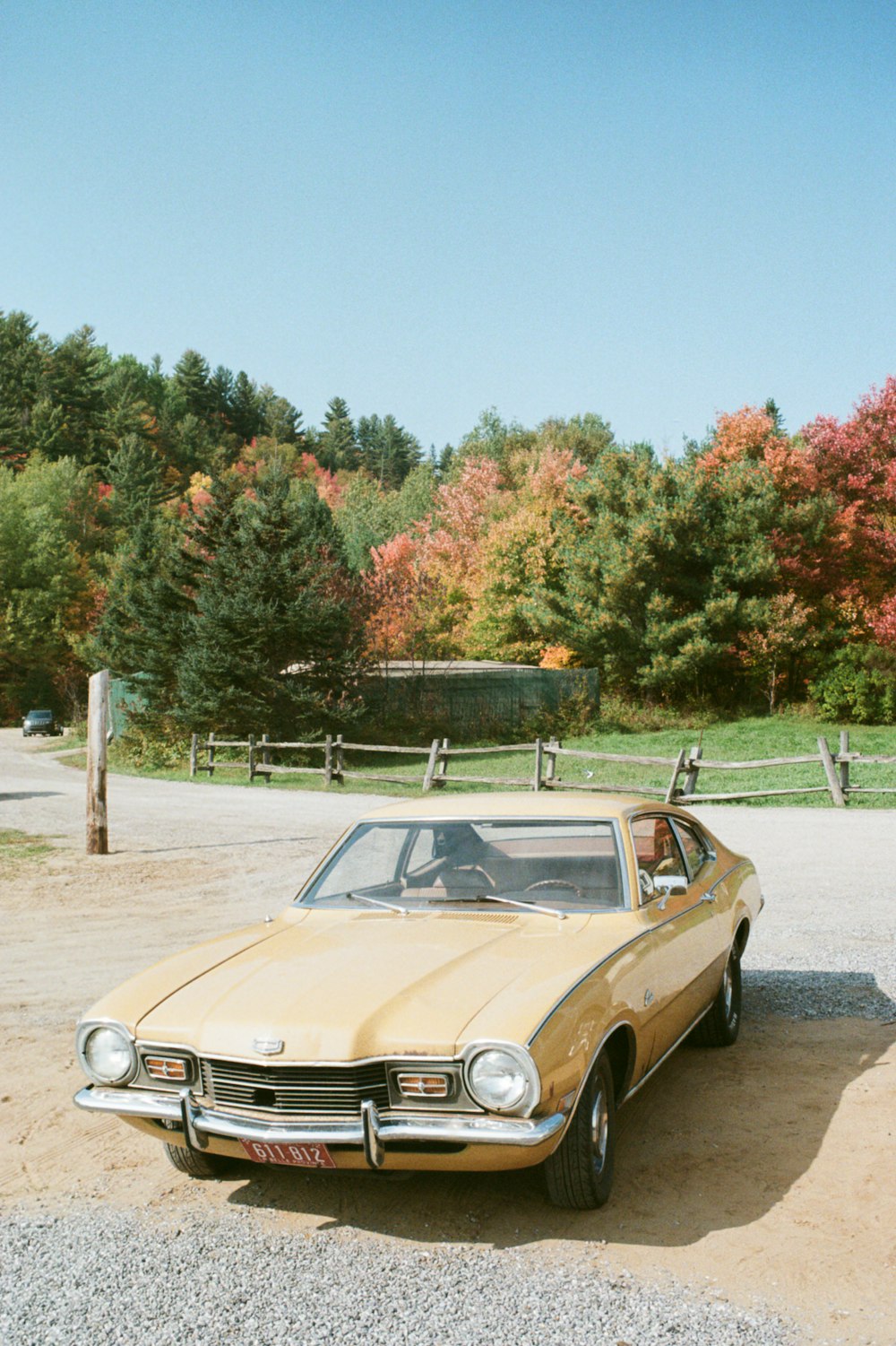 brown and white vintage car parked on gray asphalt road during daytime