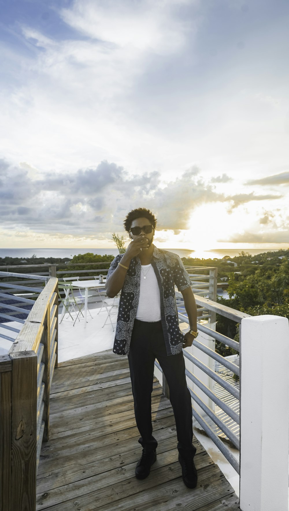 woman in black pants standing on wooden dock during daytime