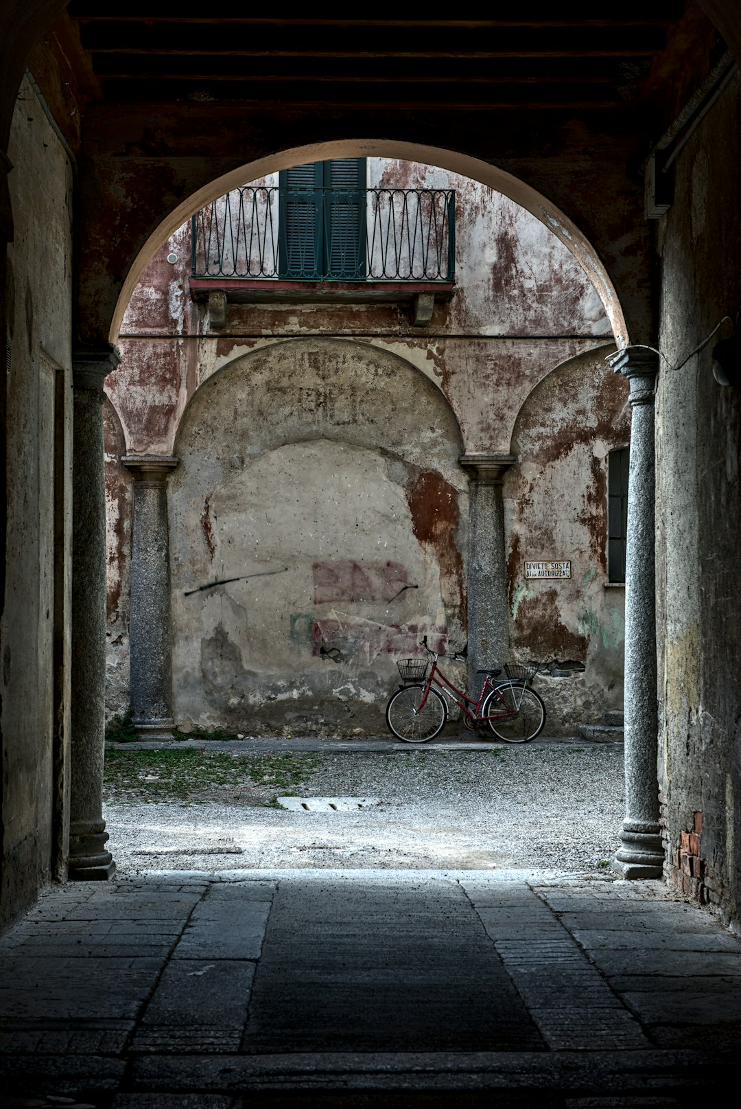 black bicycle parked beside brown concrete building during daytime