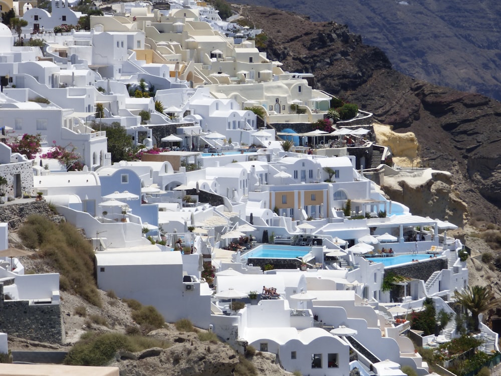 white concrete houses on brown mountain during daytime