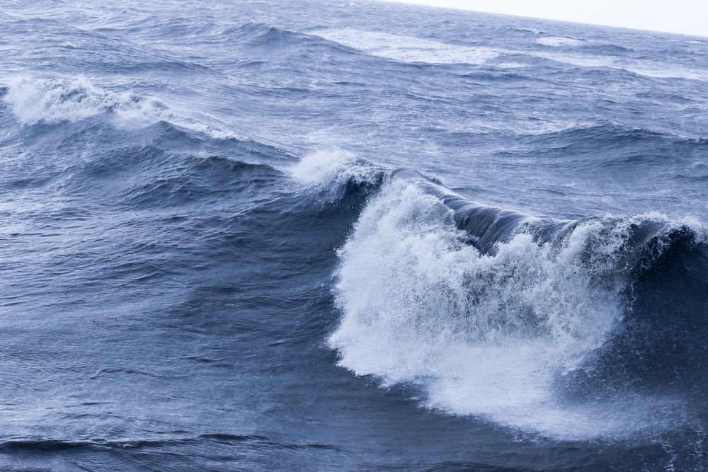 ocean waves crashing on shore during daytime