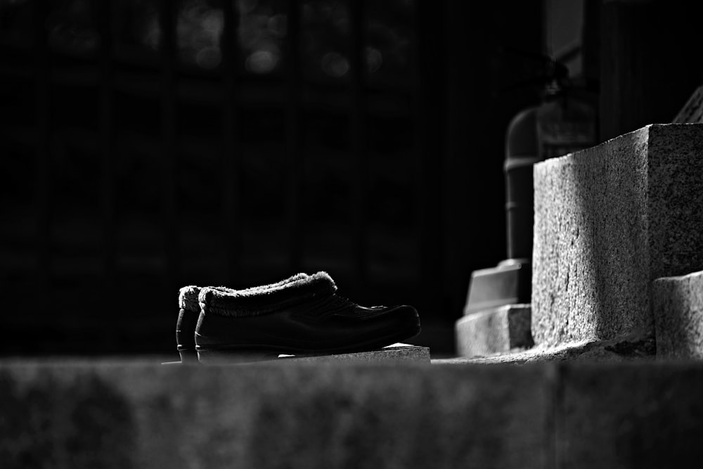 black leather shoes on concrete blocks
