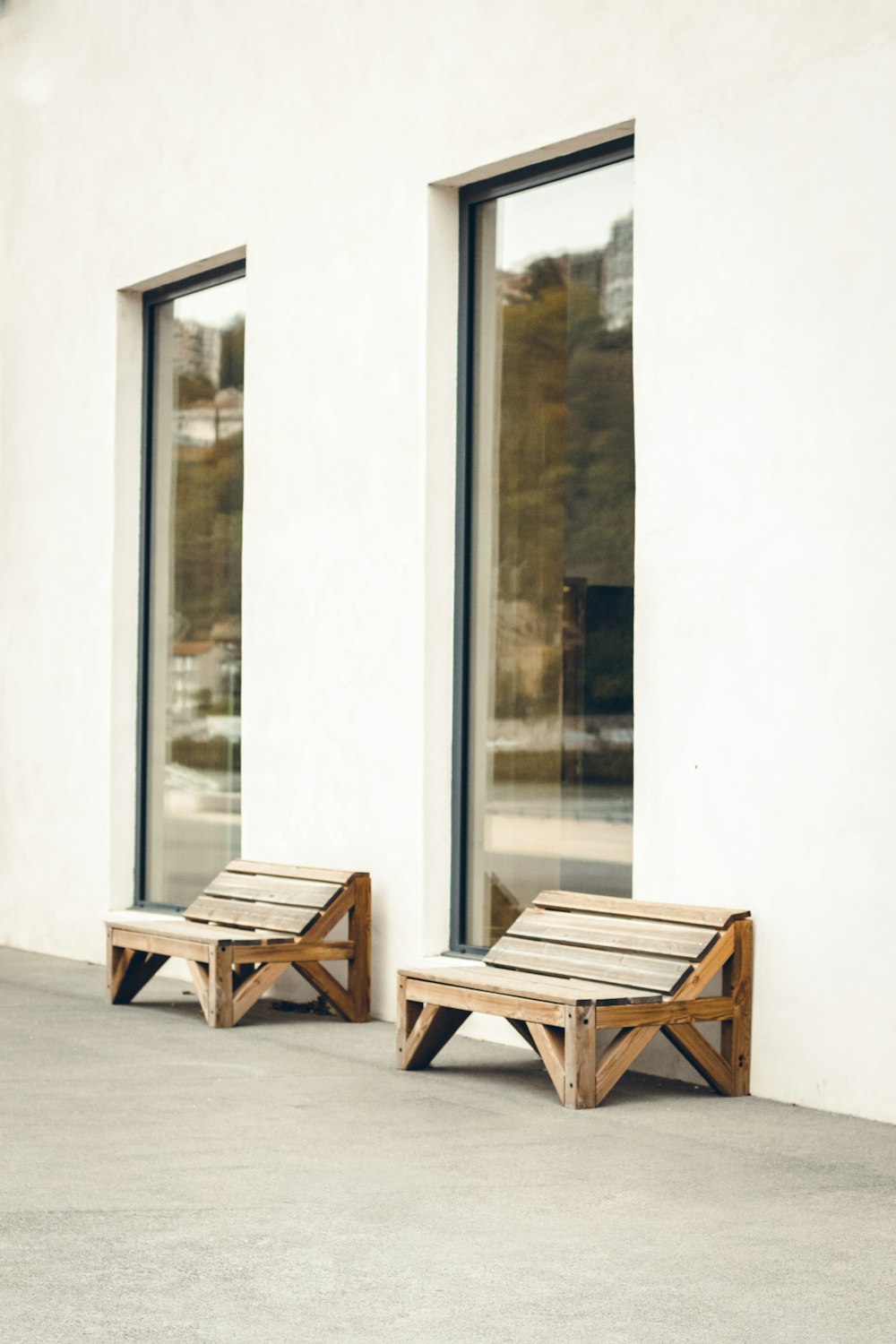 brown wooden chair beside glass wall